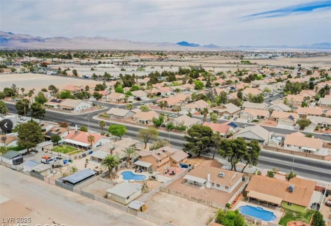 2829 Michael Way Las Vegas, NV 89108 - Photo 2 of 60 Aerial perspective of suburban area with a mountainous background and a pool