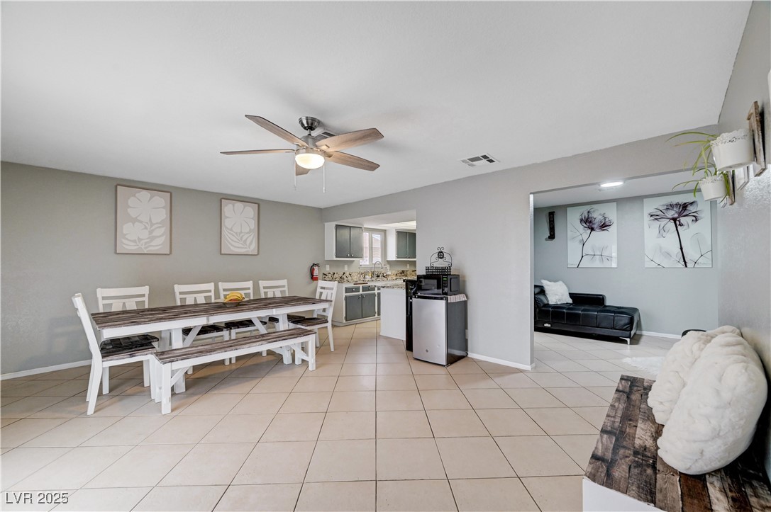 2829 Michael Way Las Vegas, NV 89108 - Photo 24 of 60 Kitchen with light tile patterned flooring, a ceiling fan, tasteful backsplash, light countertops, and fridge