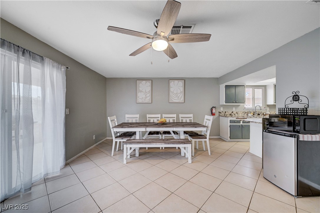 2829 Michael Way Las Vegas, NV 89108 - Photo 25 of 60 Dining space with light tile patterned floors and ceiling fan