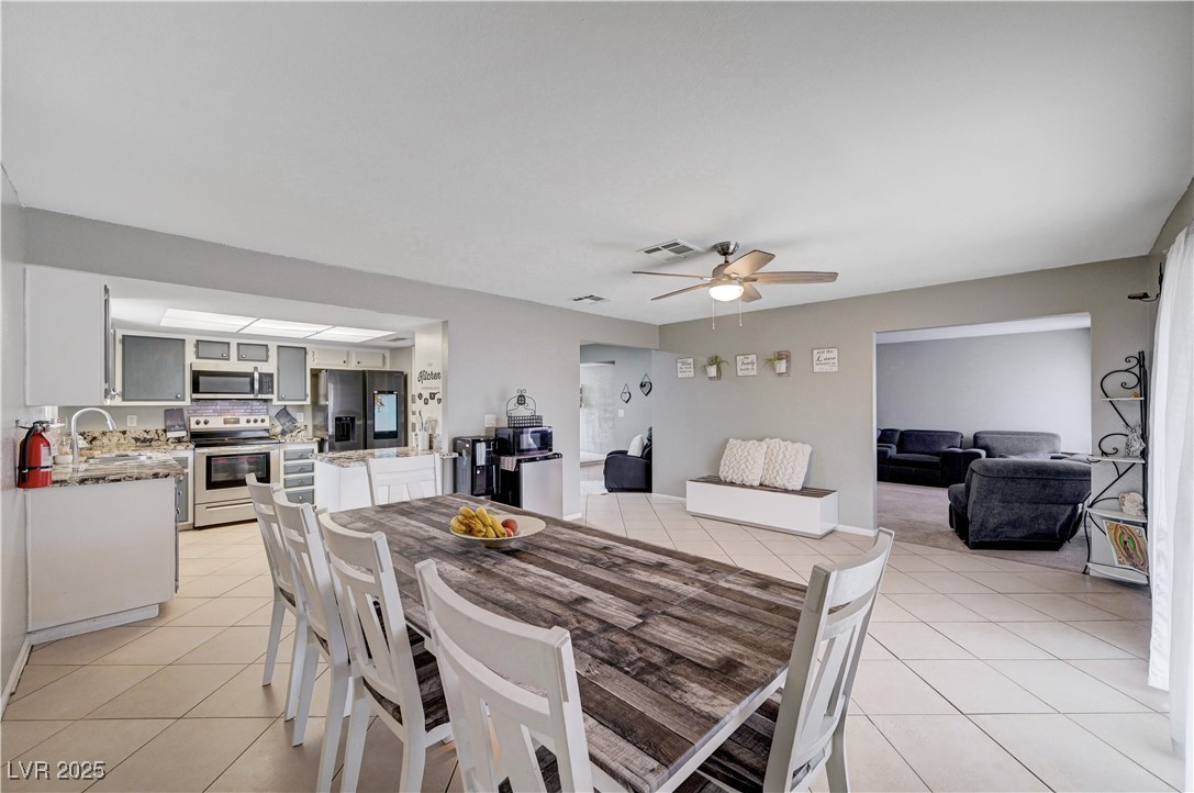 2829 Michael Way Las Vegas, NV 89108 - Photo 29 of 60 Dining room with light tile patterned flooring and ceiling fan