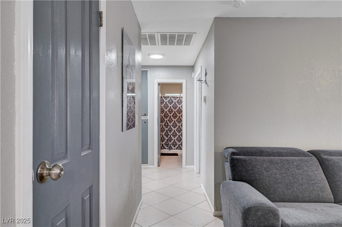 2829 Michael Way Las Vegas, NV 89108 - Photo 37 of 60 Corridor with light tile patterned flooring and baseboards