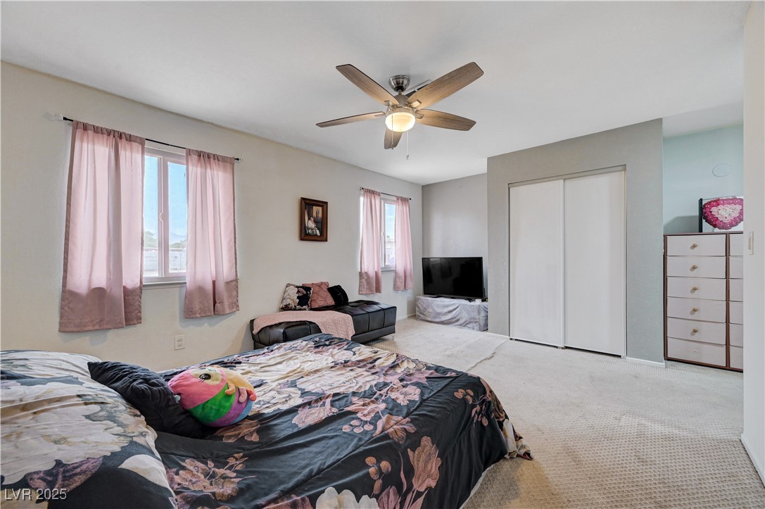 2829 Michael Way Las Vegas, NV 89108 - Photo 42 of 60 Bedroom with carpet, a closet, and ceiling fan