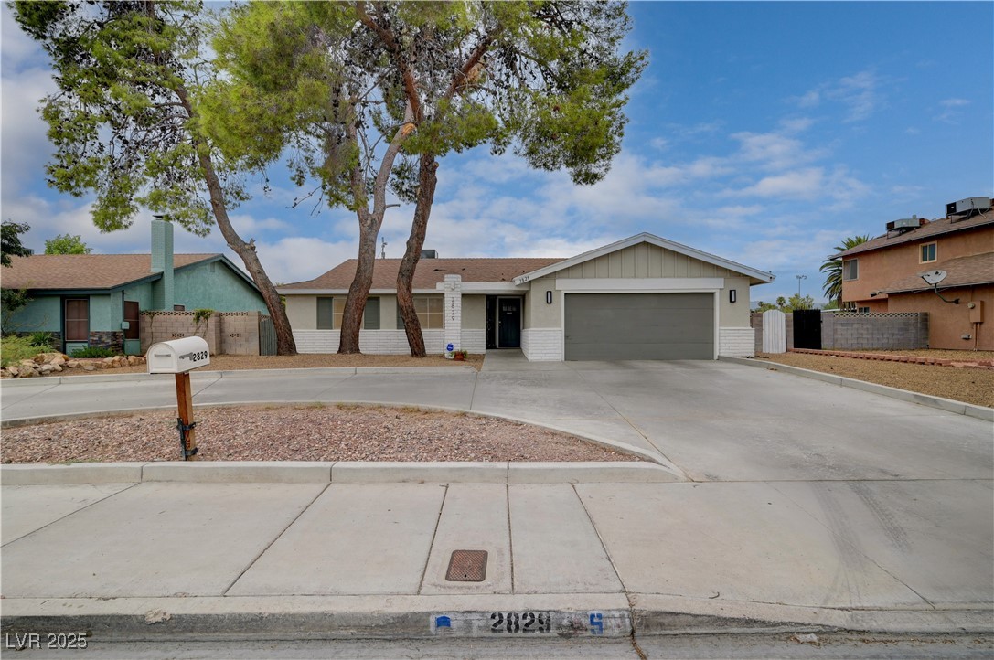 2829 Michael Way Las Vegas, NV 89108 - Photo 8 of 60 Ranch-style home featuring driveway, brick siding, and an attached garage