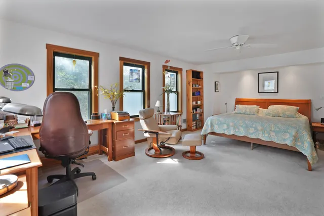 a bedroom with a workspace