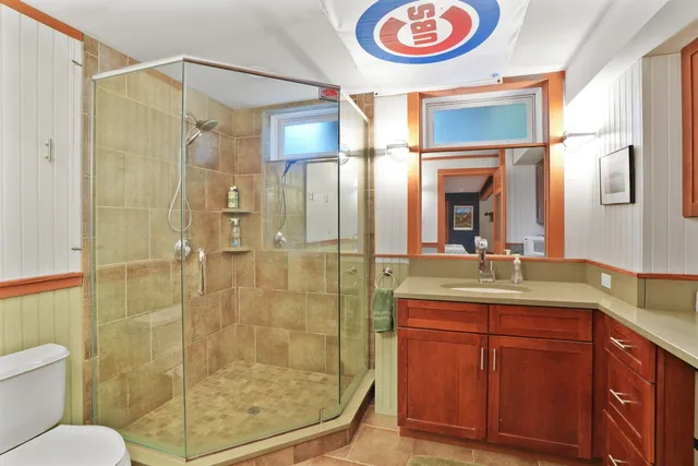a bathroom with a granite countertop sink mirror shower and toilet