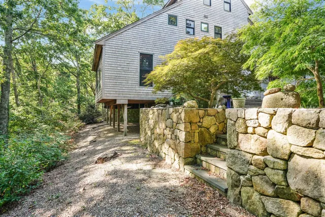 a view of a house with a yard and sitting area