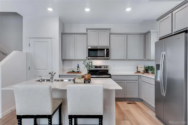 a kitchen with a sink cabinets and refrigerator