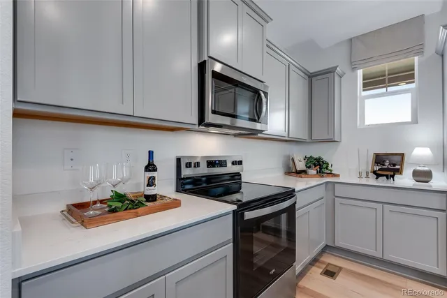 a kitchen with appliances cabinets and a window