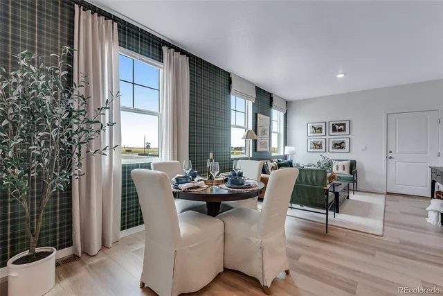 a dining room with furniture and wooden floor
