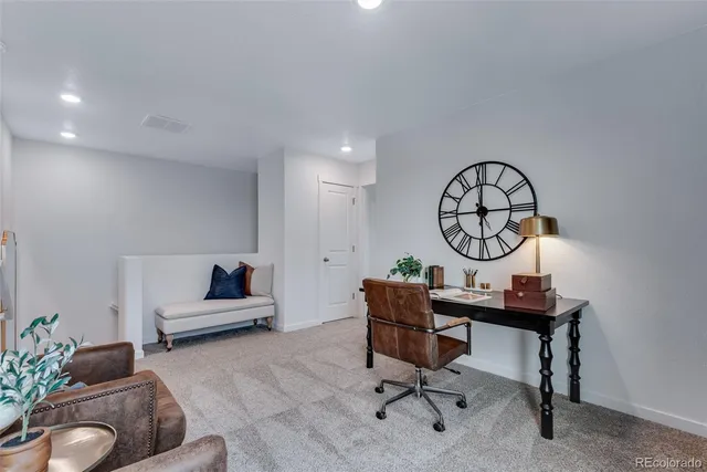 a view of a livingroom with furniture and a potted plant