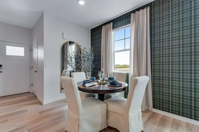 a dining room with furniture and window