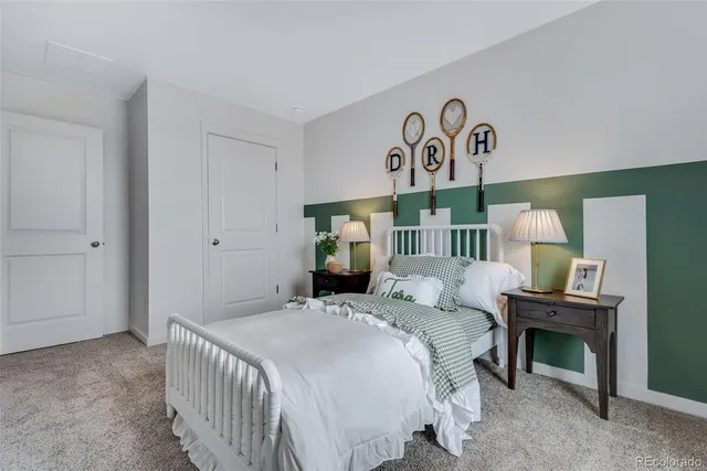 a bedroom with a bed and a lamp on table