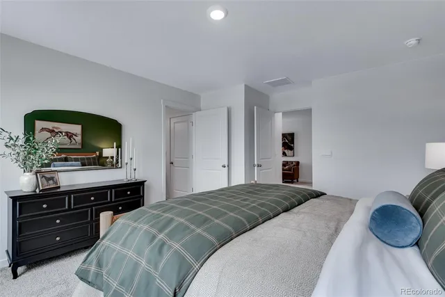 a bedroom with a bed and a television