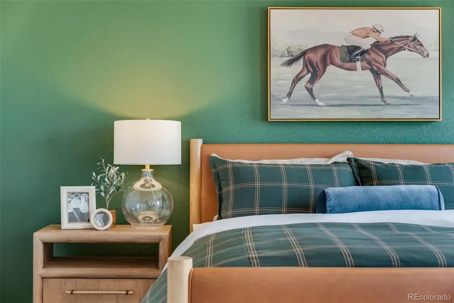 a room with a bed and wall painting