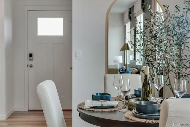 a dining room with furniture and wooden floor