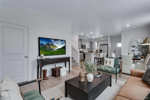 a living room with fireplace furniture and a flat screen tv