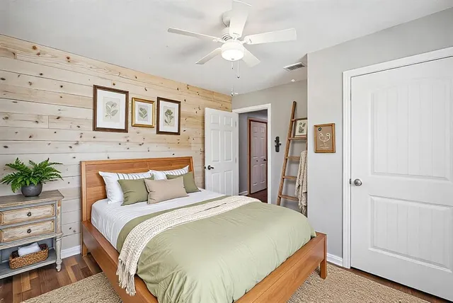 a bedroom with a large bed and a chandelier