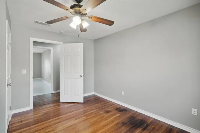 a view of an empty room and wooden floor