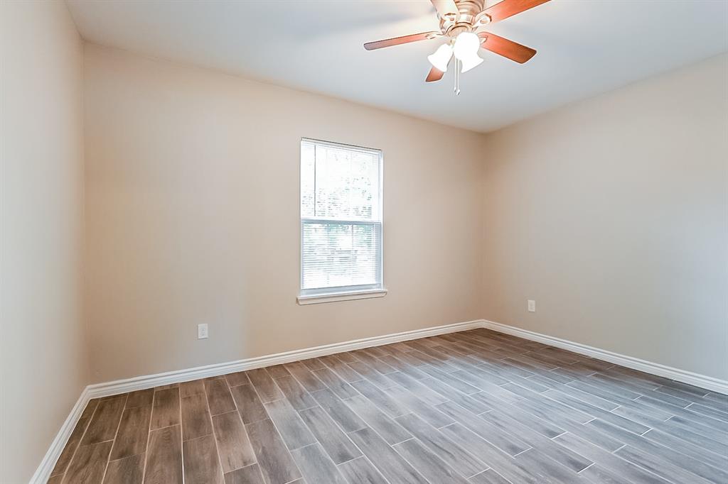 3623 Softcloud Drive Dallas, TX 75241 - Photo 11 of 16 wooden floor in an empty room with a window