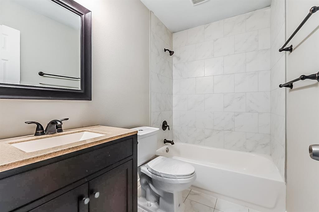 3623 Softcloud Drive Dallas, TX 75241 - Photo 13 of 16 a bathroom with a sink a toilet and shower