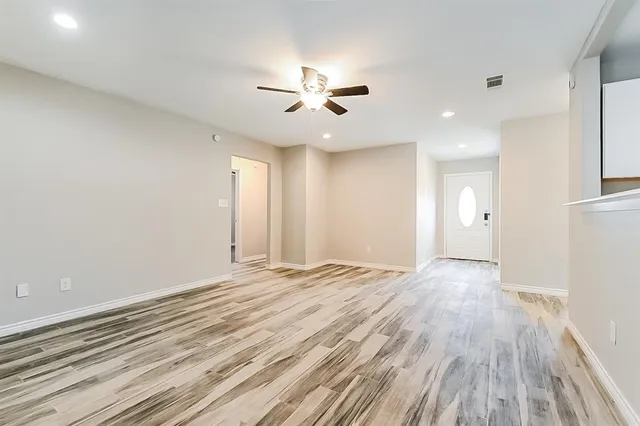 wooden floor in an empty room with a window