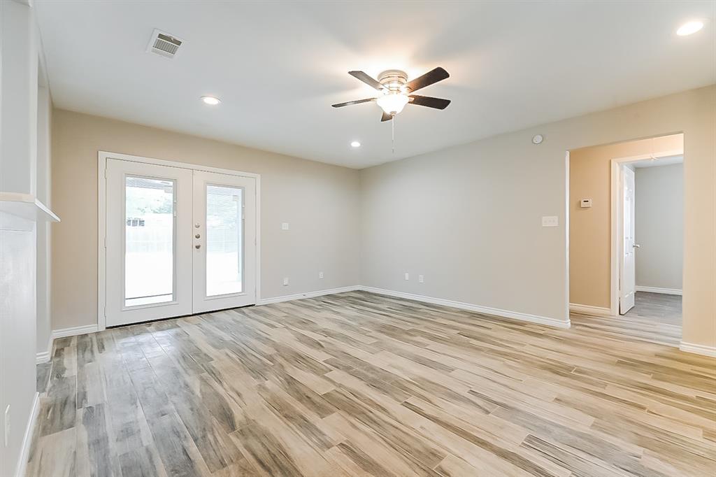 3623 Softcloud Drive Dallas, TX 75241 - Photo 3 of 16 a view of an empty room with wooden floor and window