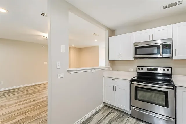 a kitchen with a stove microwave and sink