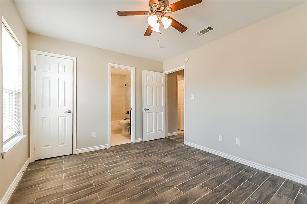 3623 Softcloud Drive Dallas, TX 75241 - Photo 8 of 16 wooden floor in an empty room with a window