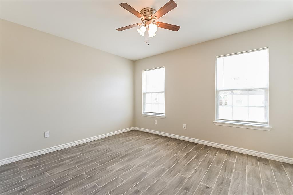 3623 Softcloud Drive Dallas, TX 75241 - Photo 9 of 16 wooden floor in an empty room with a window