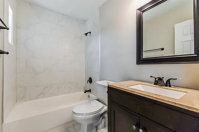 a bathroom with a sink a toilet and a bathtub