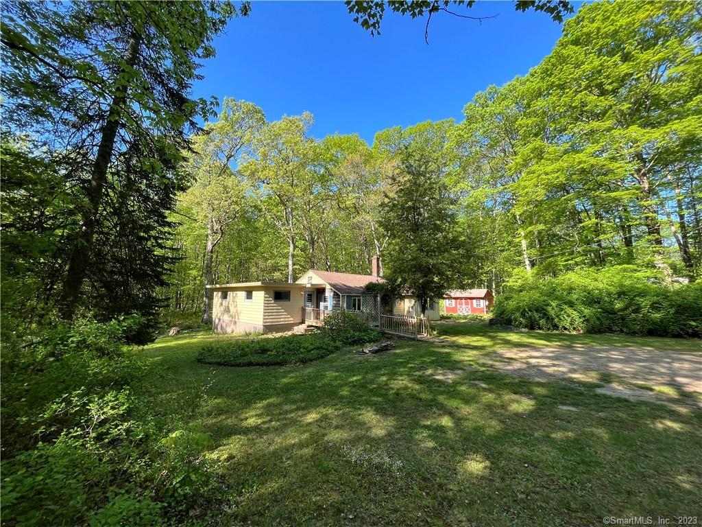 181 New Road Tolland, CT 06084 - Photo 1 of 1 a backyard of a house with table and chairs