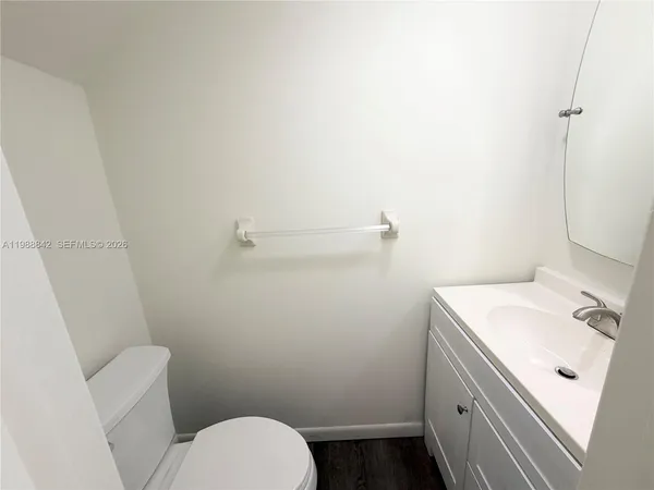 a bathroom with a sink toilet and mirror