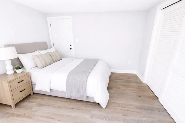 a bed room with a bed and a night stand