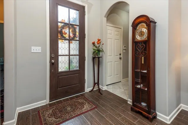a living room with furniture potted plant and a large window