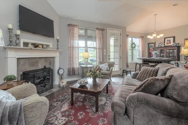 a living room with furniture a flat screen tv and a fireplace