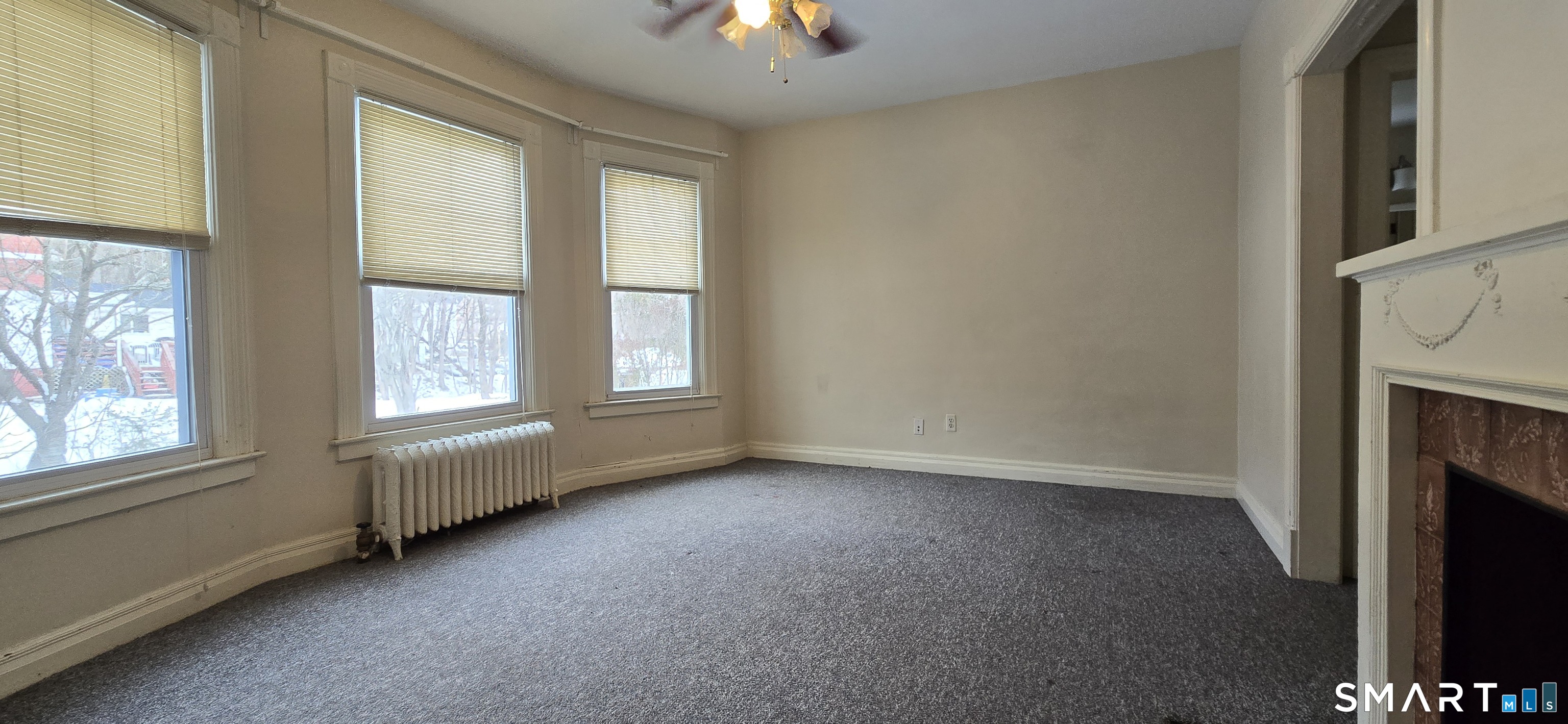 40 Maple Grove Avenue Norwich, CT 06360 - Photo 6 of 18 an empty room with windows and fireplace