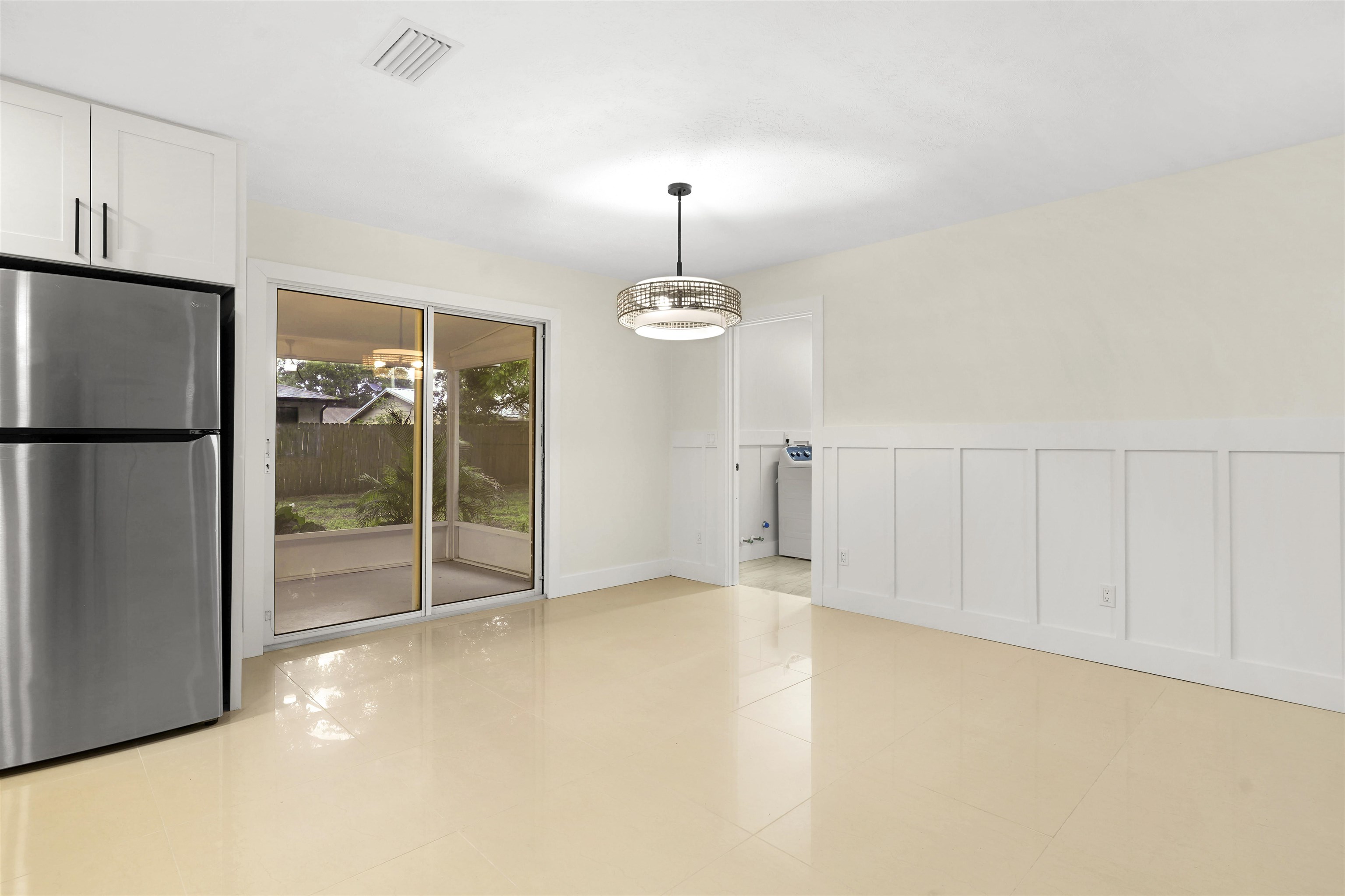 212 F Street St. Augustine, FL 32080 - Photo 13 of 35 a view of an empty room with cabinet and chandelier