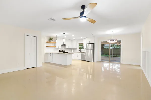 a view of a kitchen with a sink and a refrigerator
