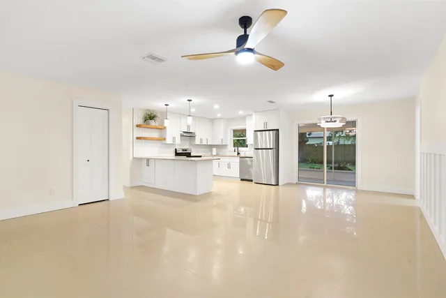a view of a kitchen with a sink and a refrigerator
