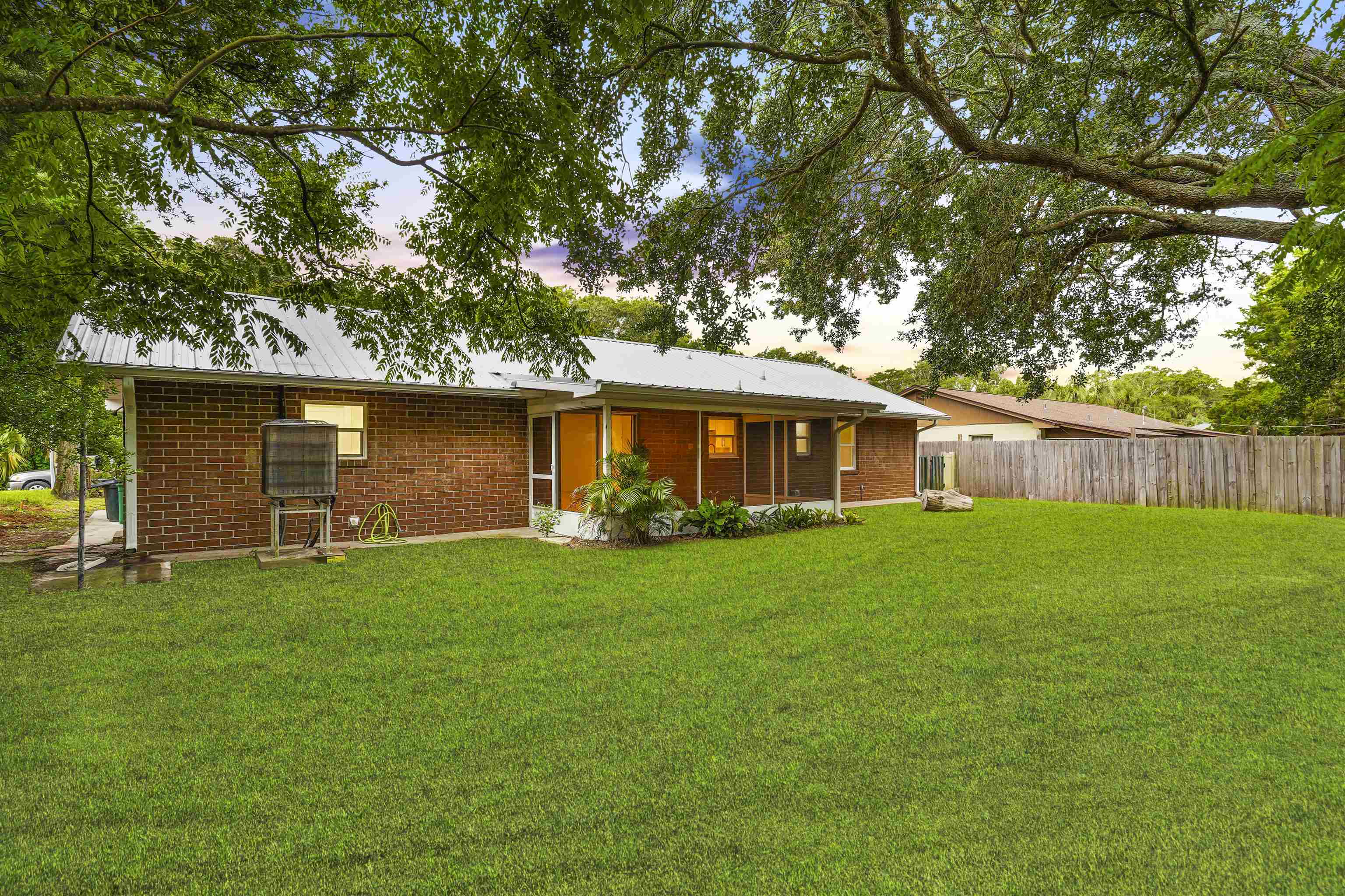 212 F Street St. Augustine, FL 32080 - Photo 28 of 35 a backyard of a house with plants and large tree