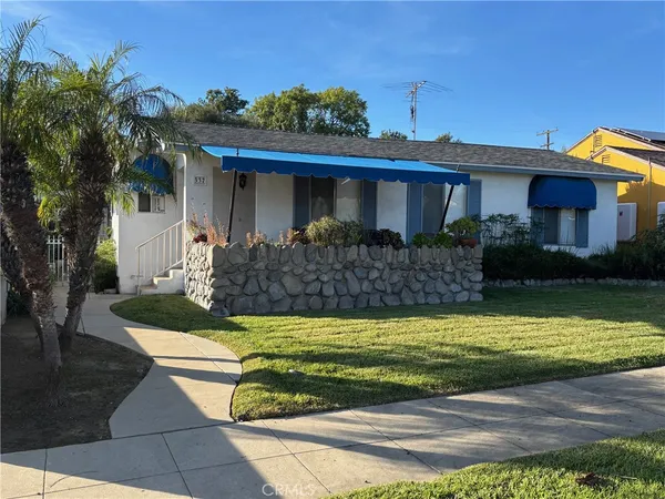 a front view of a house with garden