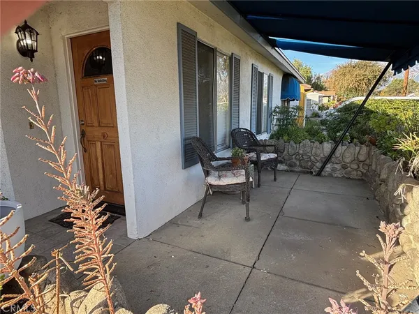 a backyard of a house with outdoor seating
