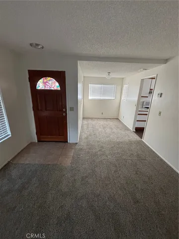 a view of empty room with a fireplace