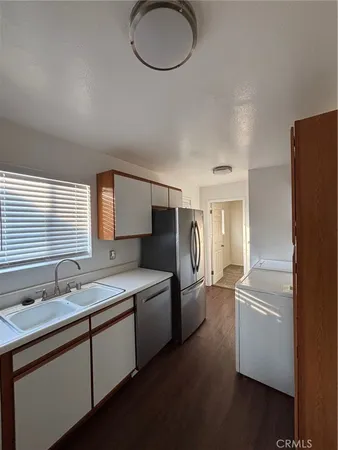 a kitchen with stainless steel appliances granite countertop a sink a refrigerator and a stove