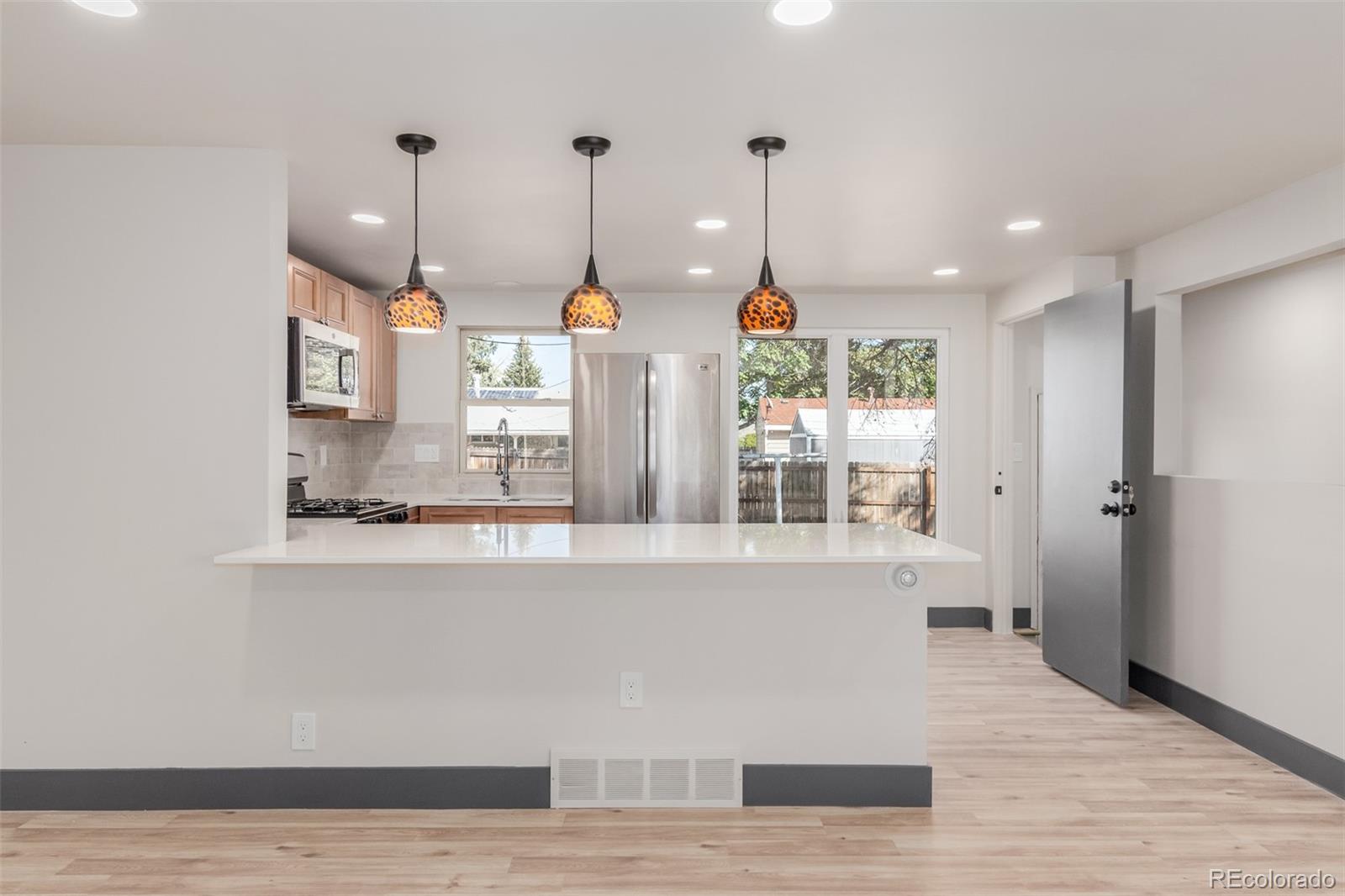 7330 Decatur Street Westminster, CO 80030 - Photo 11 of 37 a view of a kitchen with wooden floor and windows