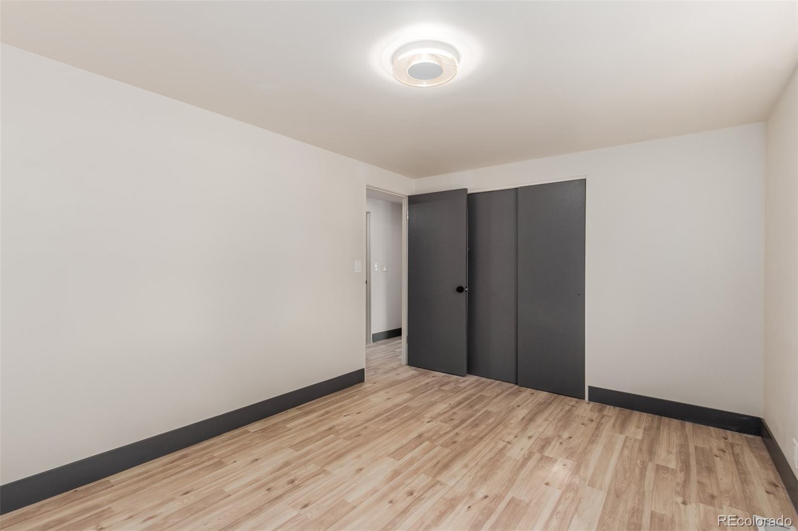 7330 Decatur Street Westminster, CO 80030 - Photo 15 of 37 a view of empty room with wooden floor