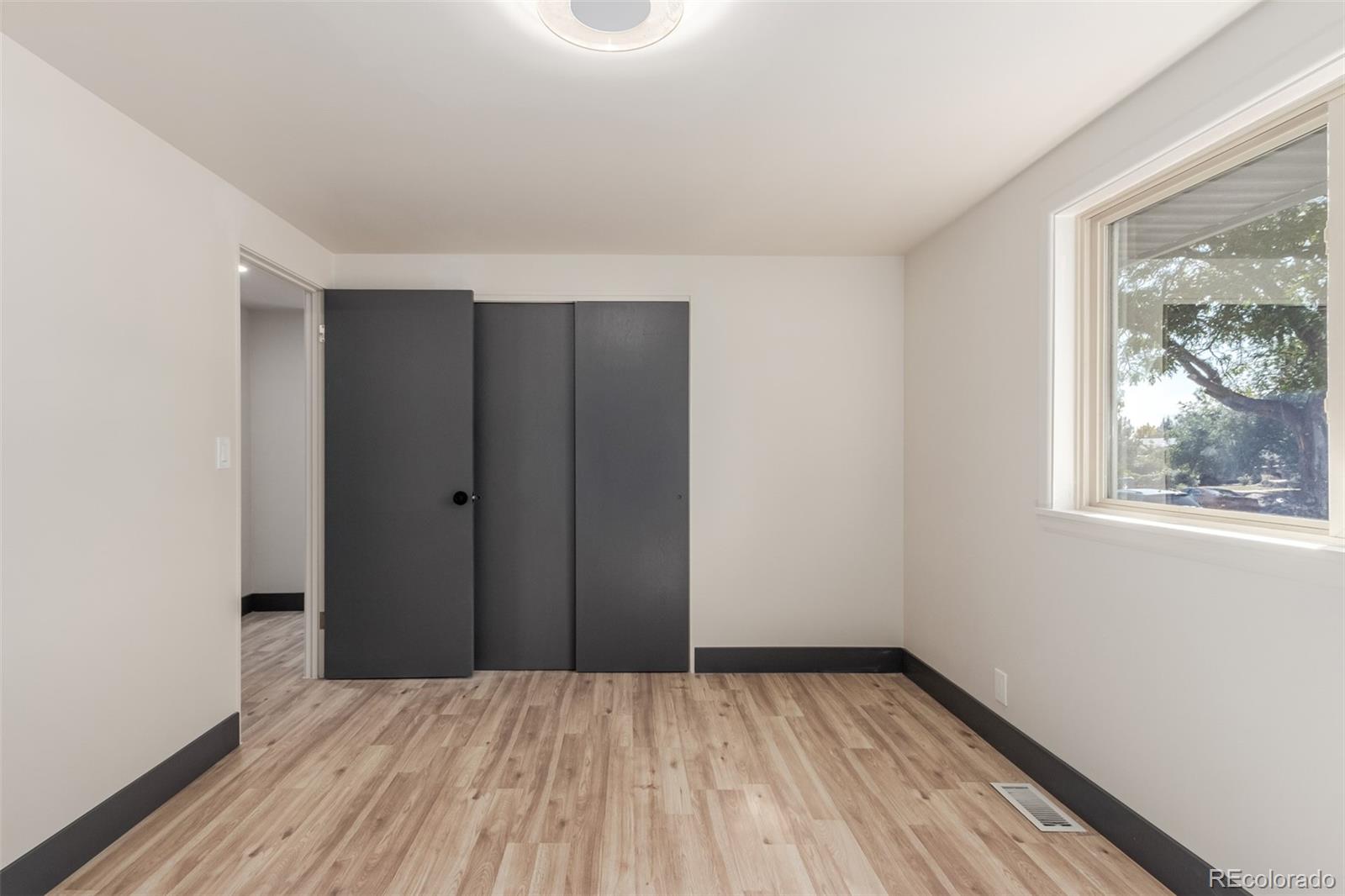 7330 Decatur Street Westminster, CO 80030 - Photo 16 of 37 a view of a room with wooden floor and window