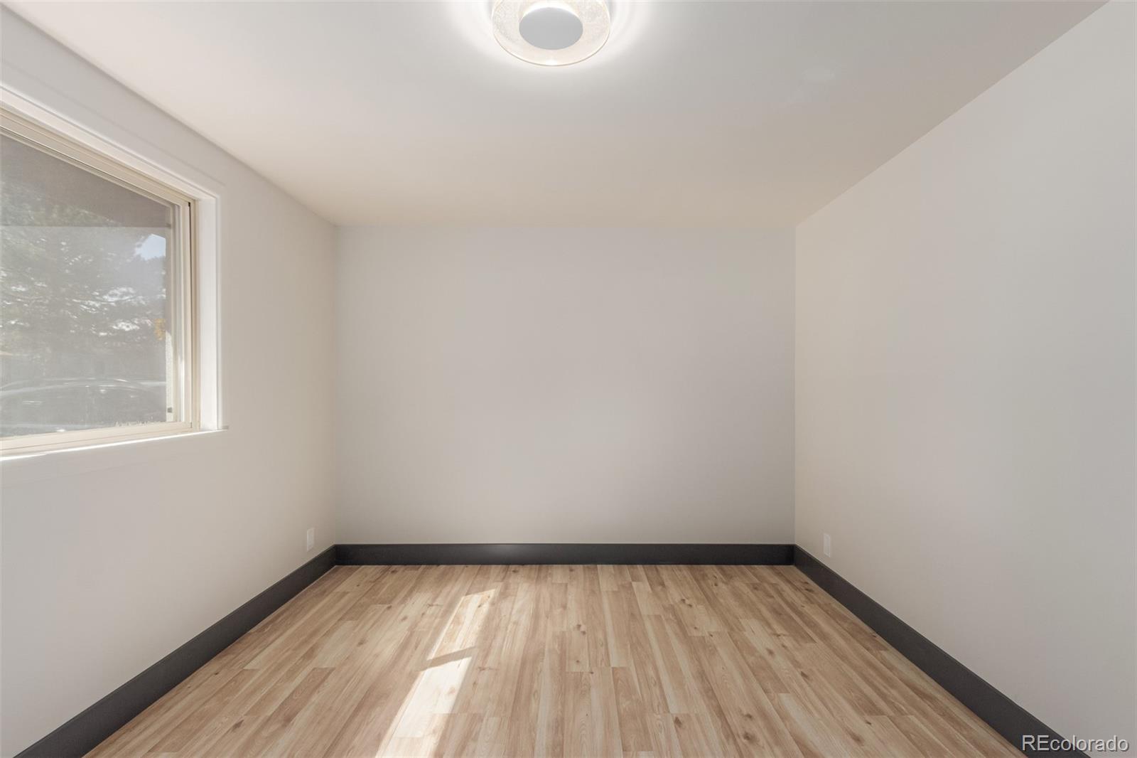 7330 Decatur Street Westminster, CO 80030 - Photo 17 of 37 a view of a room with wooden floor and window