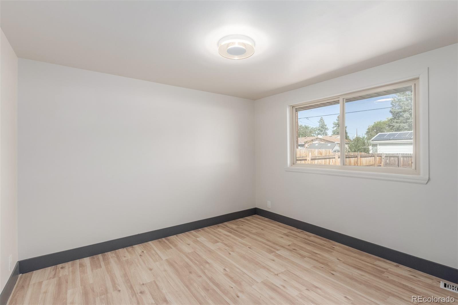 7330 Decatur Street Westminster, CO 80030 - Photo 19 of 37 wooden floor in an empty room with a window