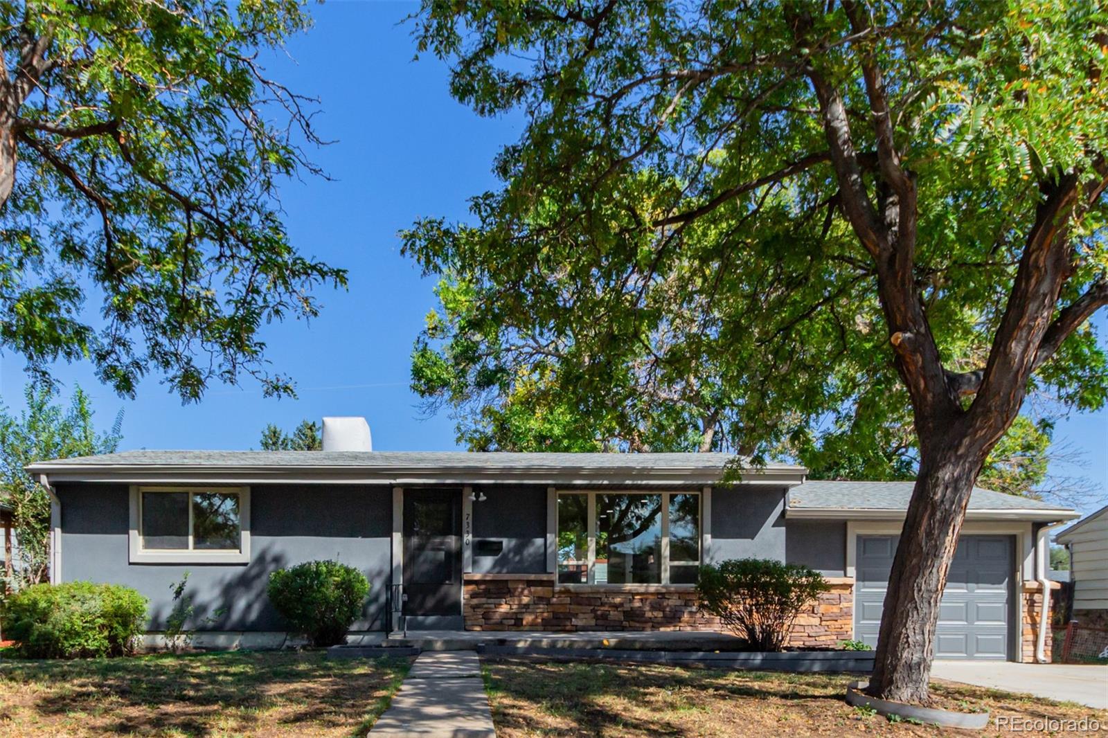 7330 Decatur Street Westminster, CO 80030 - Photo 2 of 37 a front view of house with yard and trees around